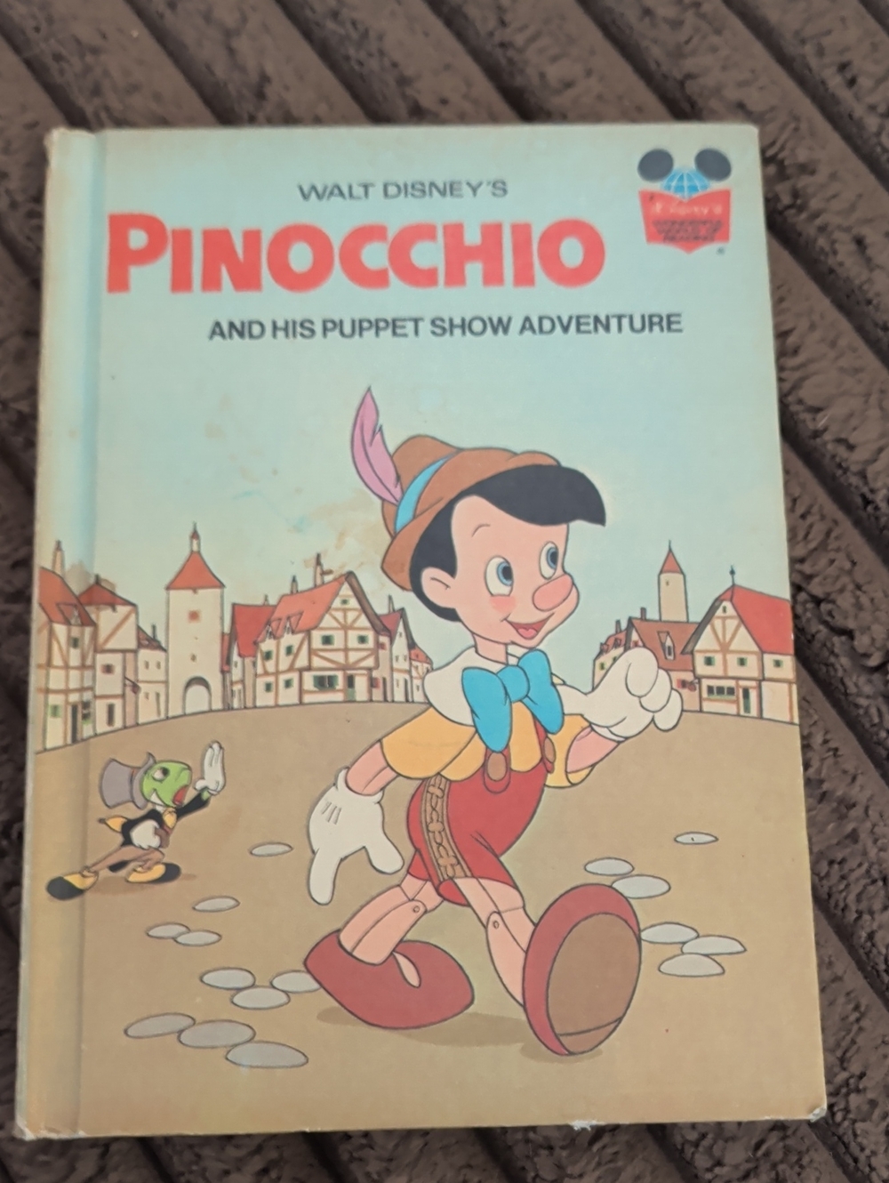 Disney Pinocchio Book Cover - Light Blue, Red & Brown Illustration